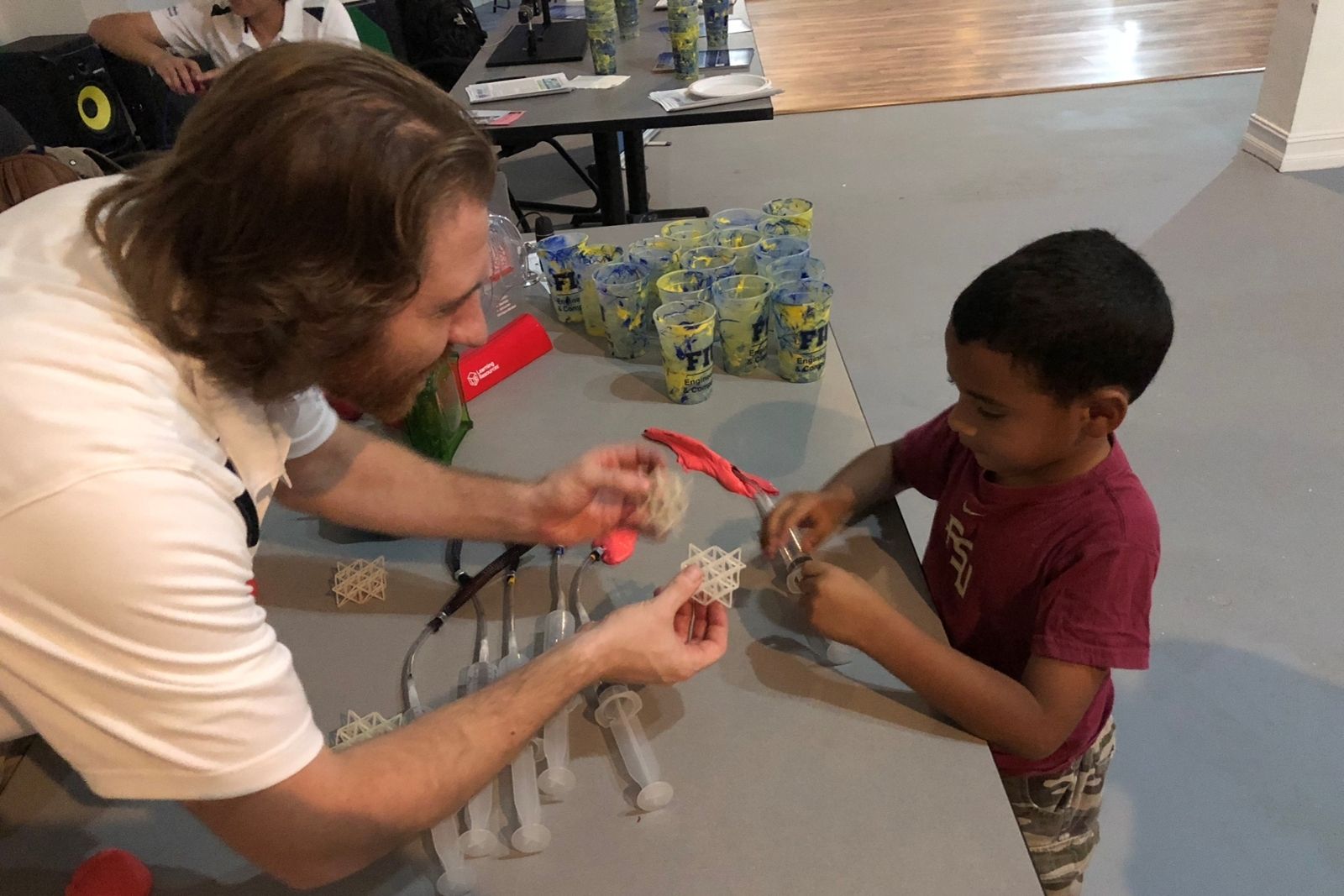 Professor working on a project with a child 